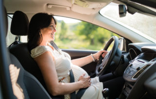 mujer embarazada al volante de un coche